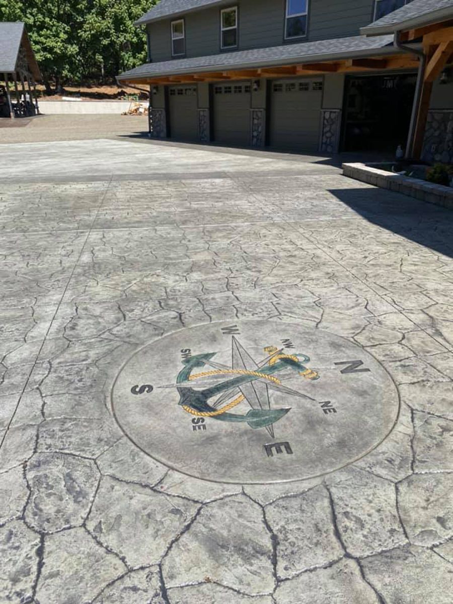 Concrete driveway with a large compass design.