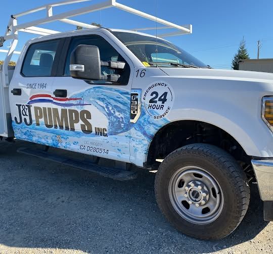 White J&J Pumps service truck parked outdoors with company branding and “24 hour” logo on the side