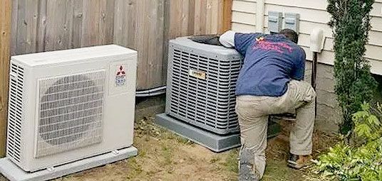 A man working on an air conditioner