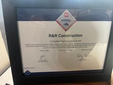 A certificate for r & r construction is sitting on a table.