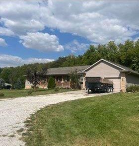 A large house with a truck parked in front of it.