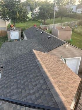 An aerial view of a house with a roof that is being installed.