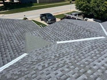 A truck is parked on the roof of a house.