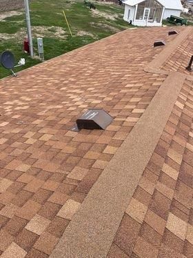 A close up of a roof with a satellite dish on it.