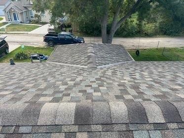 A truck is parked on the roof of a house.