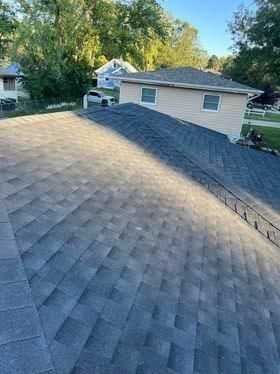A roof of a house with a ladder on it.