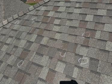 A close up of a roof with a lot of shingles on it.