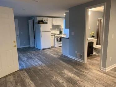 A truck is parked in front of a large brick building.