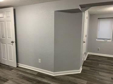 A corner of a room with a door and a window.