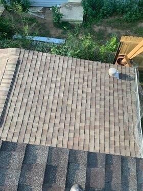 An aerial view of a roof with a chimney on it.