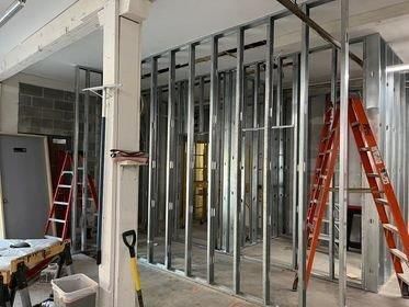 A room with a lot of metal walls and a ladder.