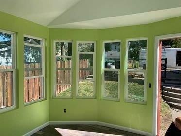 A bathroom with a toilet , sink , and cabinets.