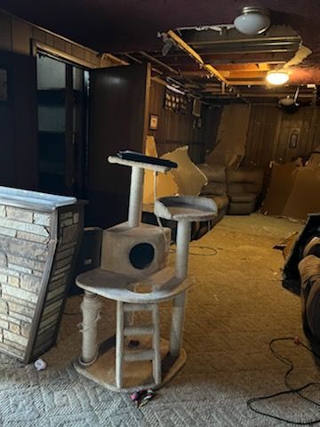 A cat tree is sitting in the middle of a living room.