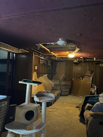 There is a cat tree in the middle of the room.