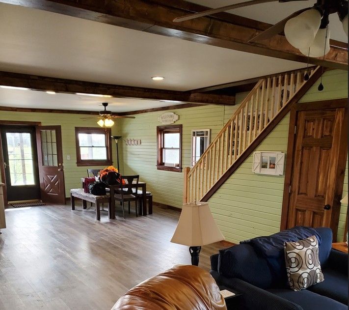 A living room with a staircase leading up to the second floor