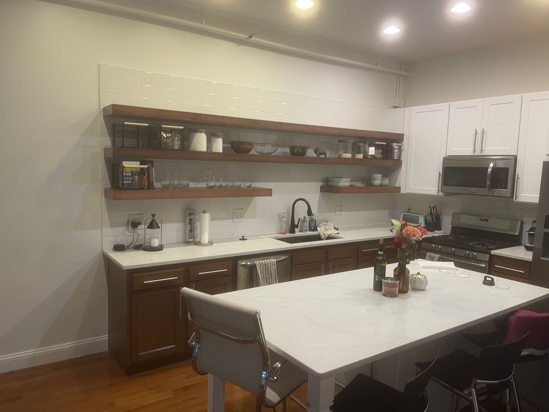 A kitchen with a table and chairs and a sink.