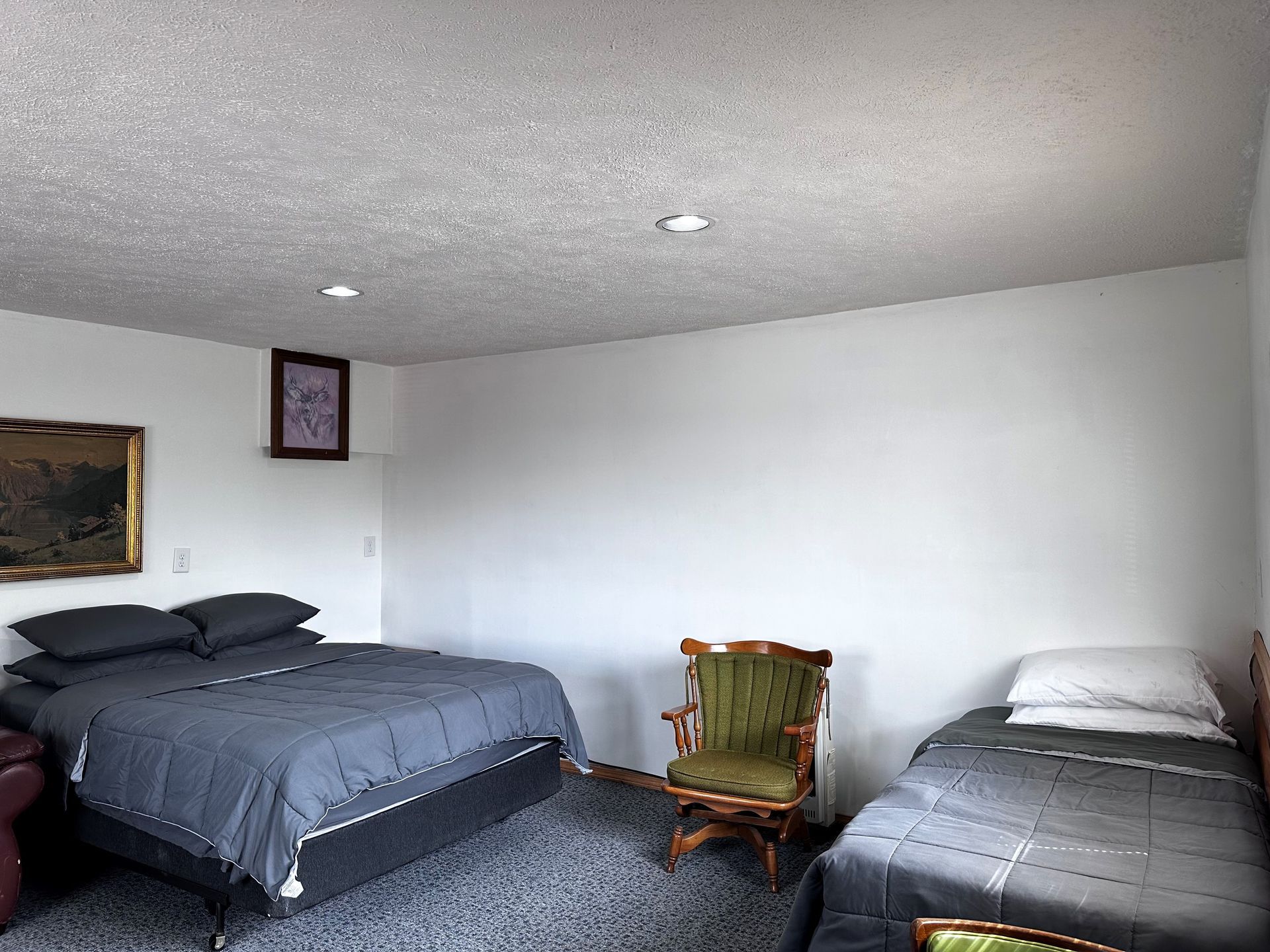 A hotel room with two beds and a chair