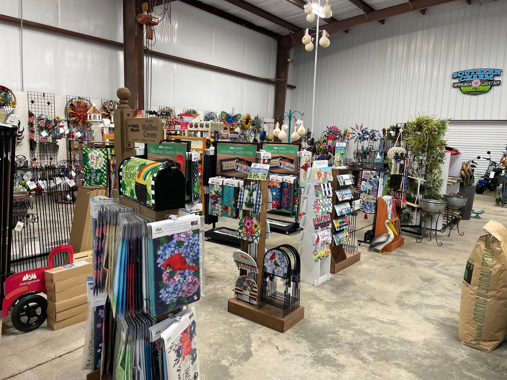 Indoor shop aisle with fishing rods, tackle, and camping gear displays