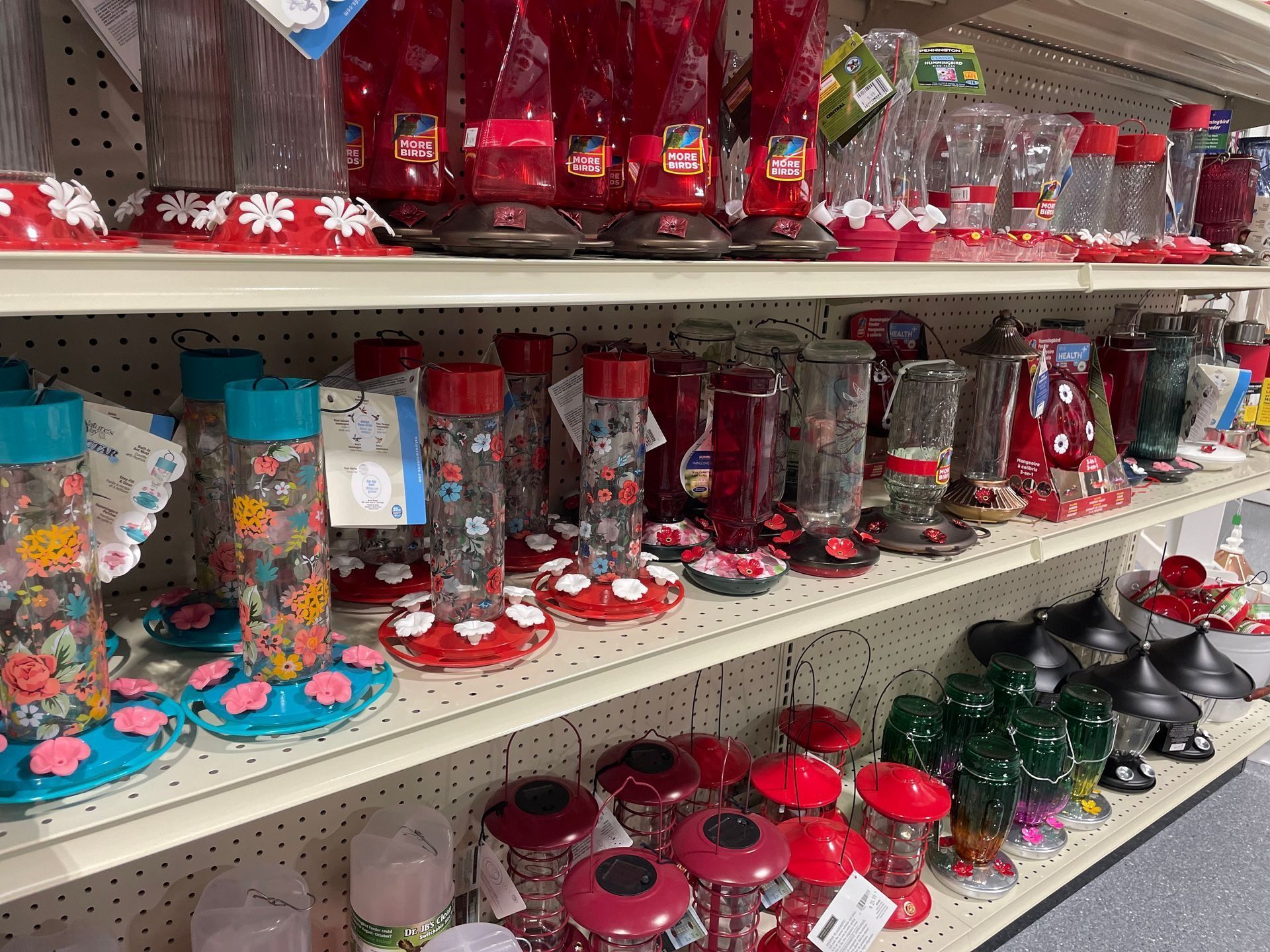 Shelves of colorful decorative candles and glass jars in a store aisle