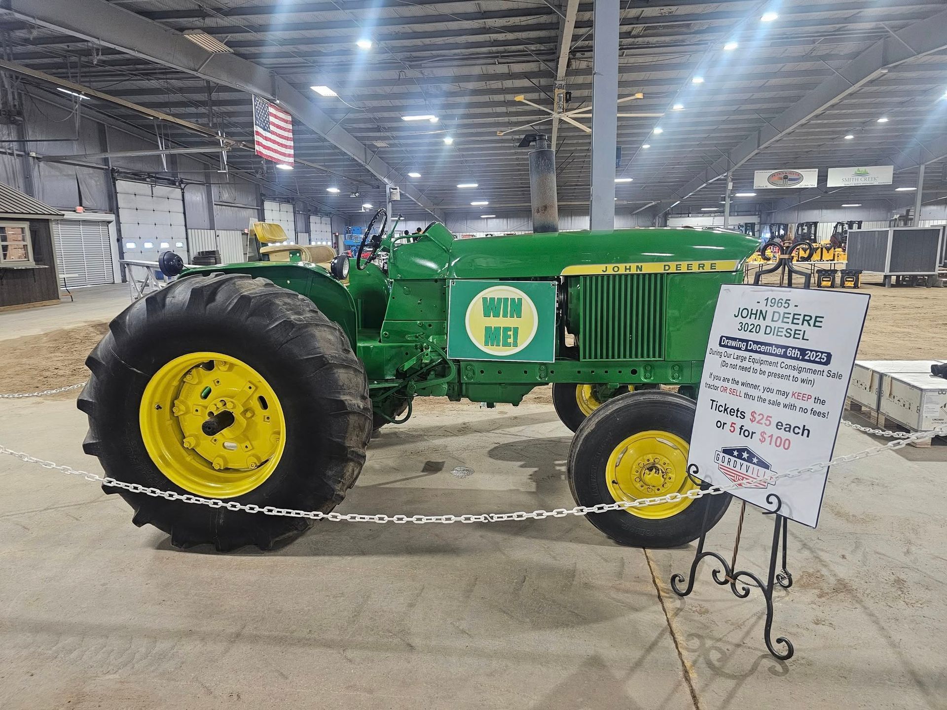 Green and yellow John Deere tractor on display with 