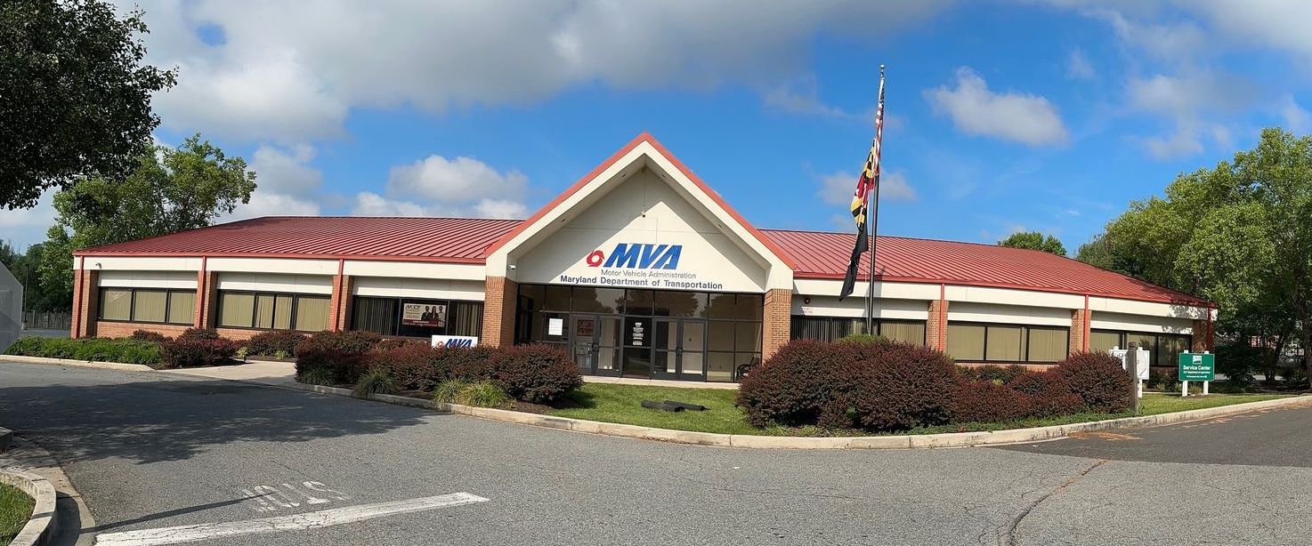 A large building with a red roof and a flag on top of it.