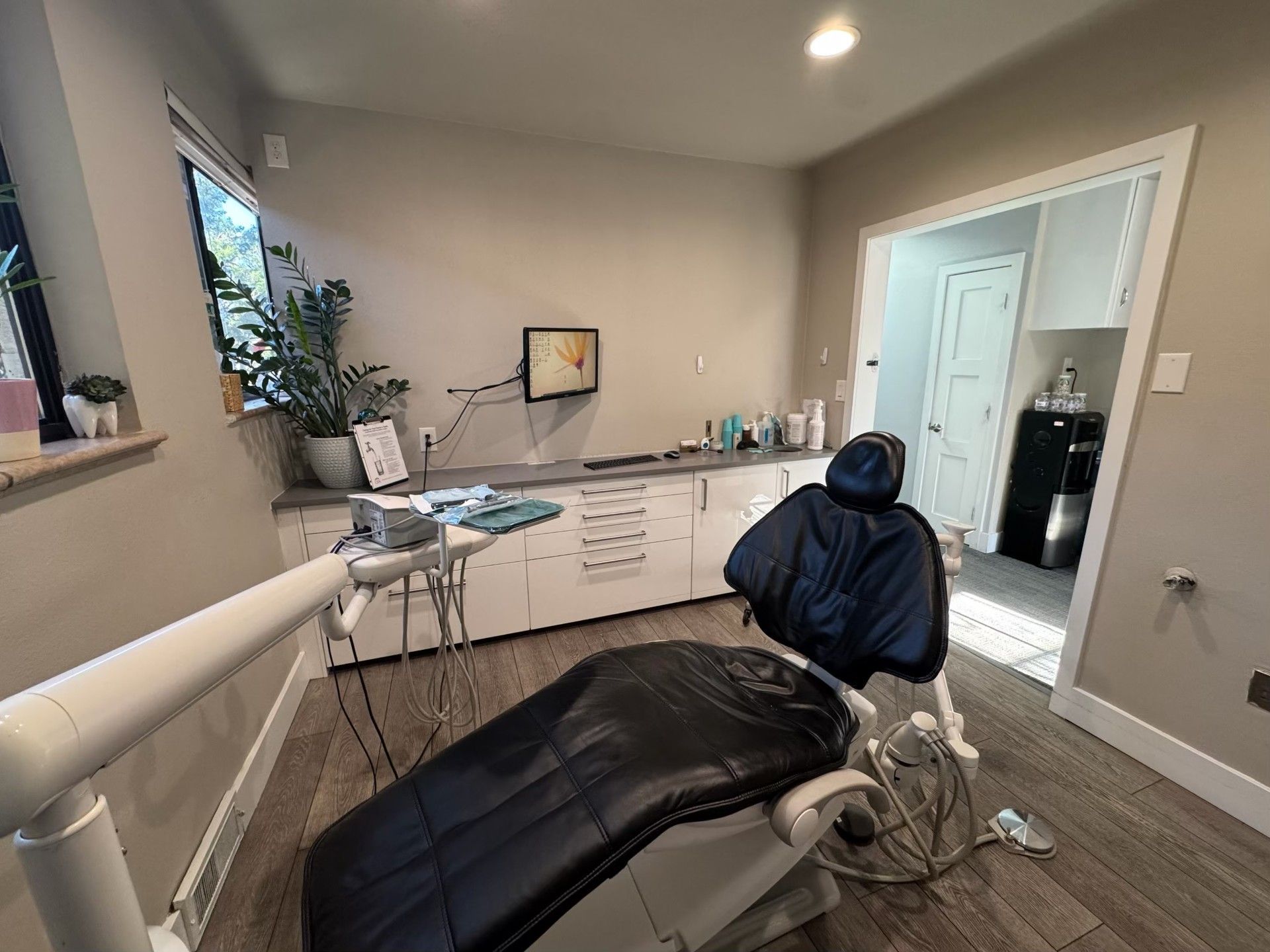 There is a dental chair in the middle of the room.