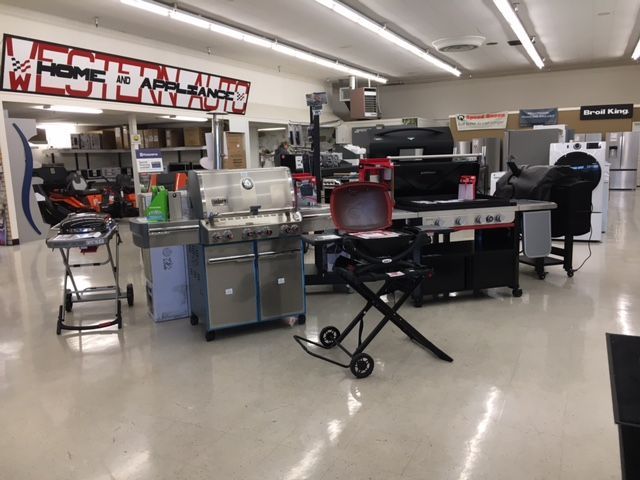 A showroom with grills and appliances on display