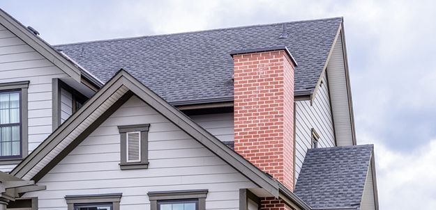 shingle roofing with brick chimney