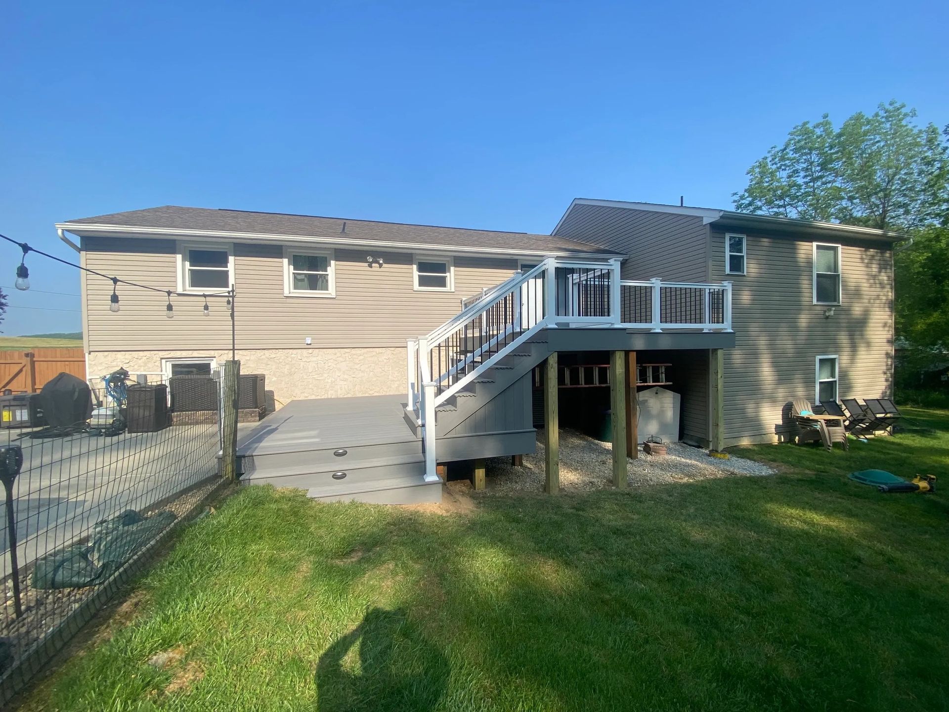 A large house with a large deck in the backyard.