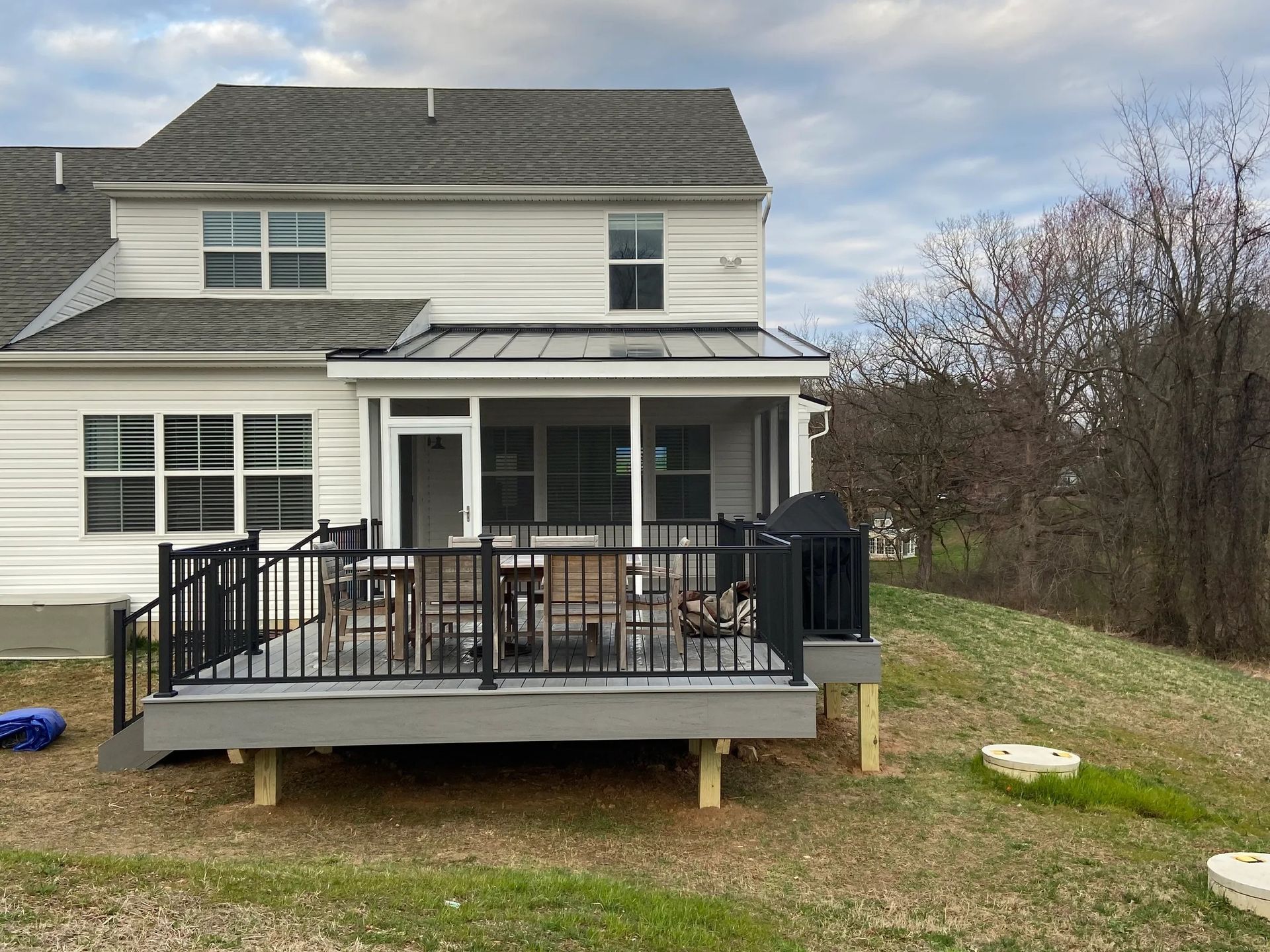 A large white house with a large deck in front of it.
