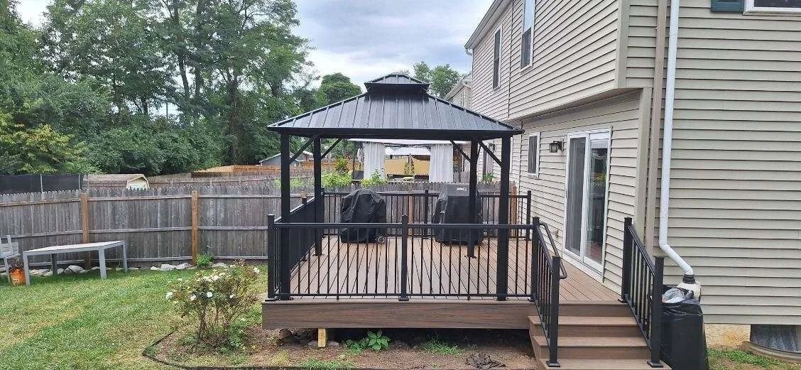 There is a gazebo in the backyard of a house.