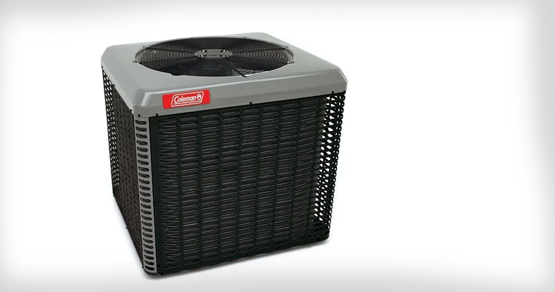 Blue furnace unit with open access panel in a basement, exposing internal components. The unit sits on a concrete base, with a metal tray below it.