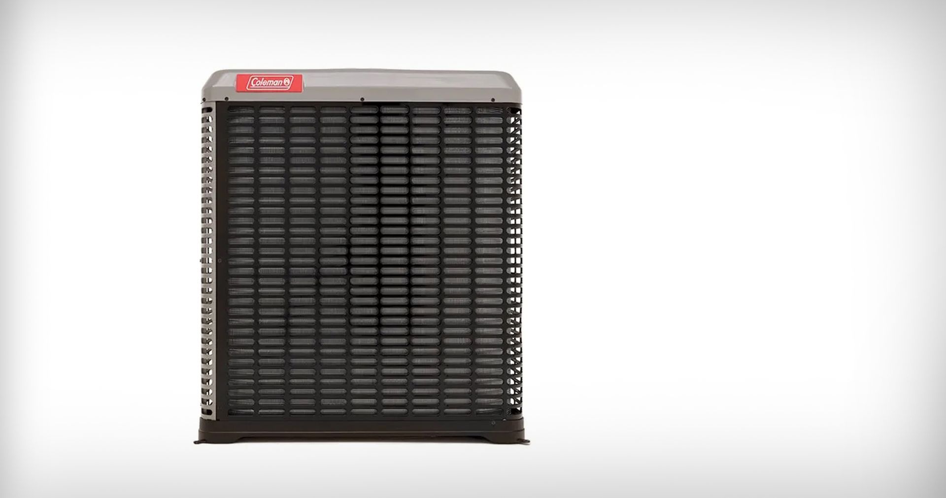 Blue furnace unit with open access panel in a basement, exposing internal components. The unit sits on a concrete base, with a metal tray below it.