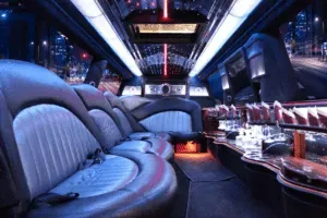 The inside of a limousine with a lot of seats and tables.