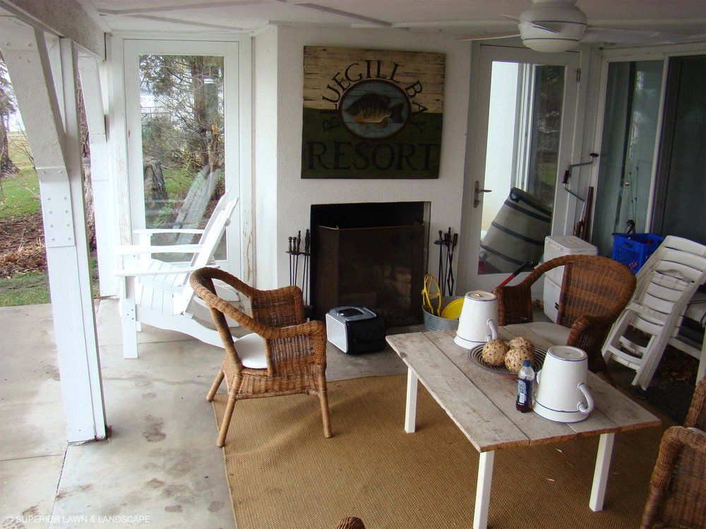 A porch with a fireplace and a sign that says resort