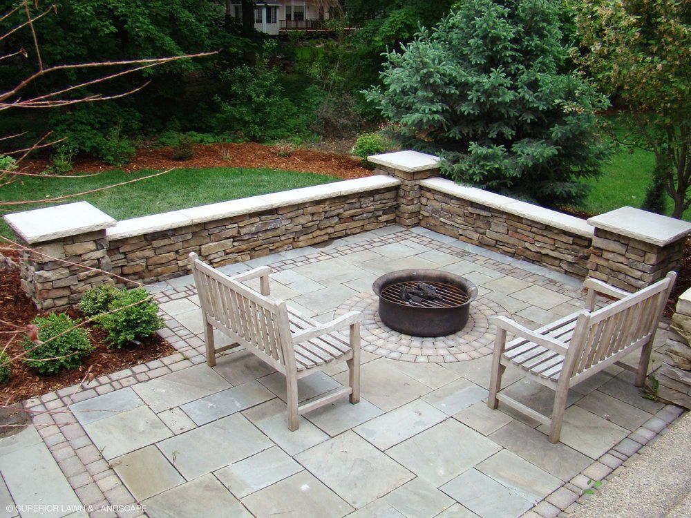 There is a fire pit in the middle of the patio.