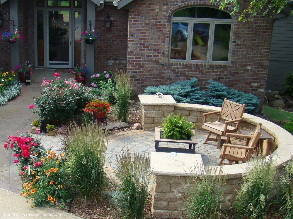 A brick house with a patio in front of it