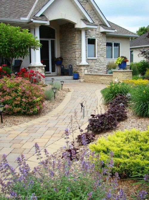 A house with a brick walkway leading to the front door