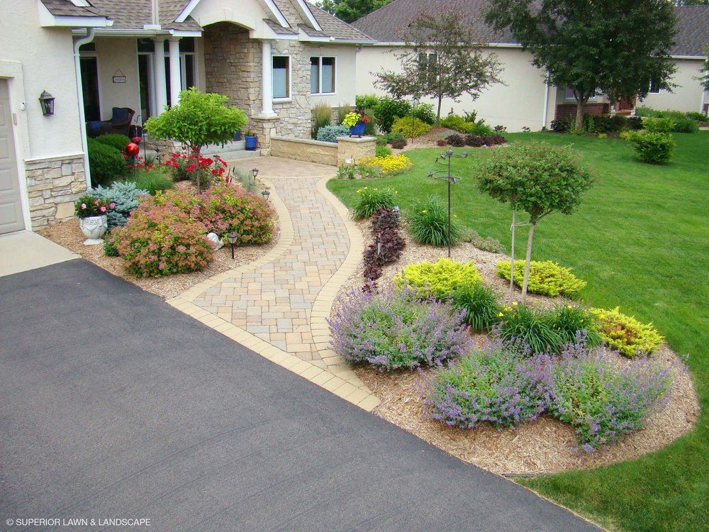 A house with a lot of plants in front of it