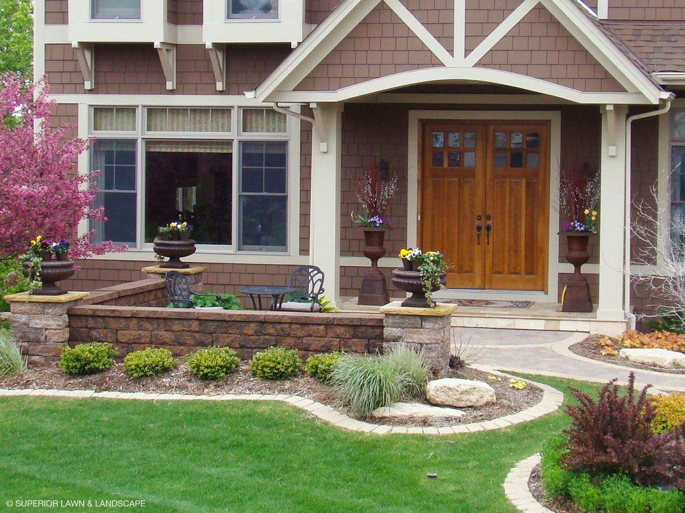 The front of a brown house with a wooden door