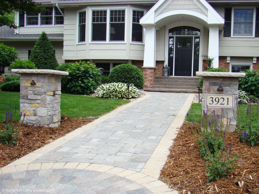 A house with a stone walkway leading to the front door