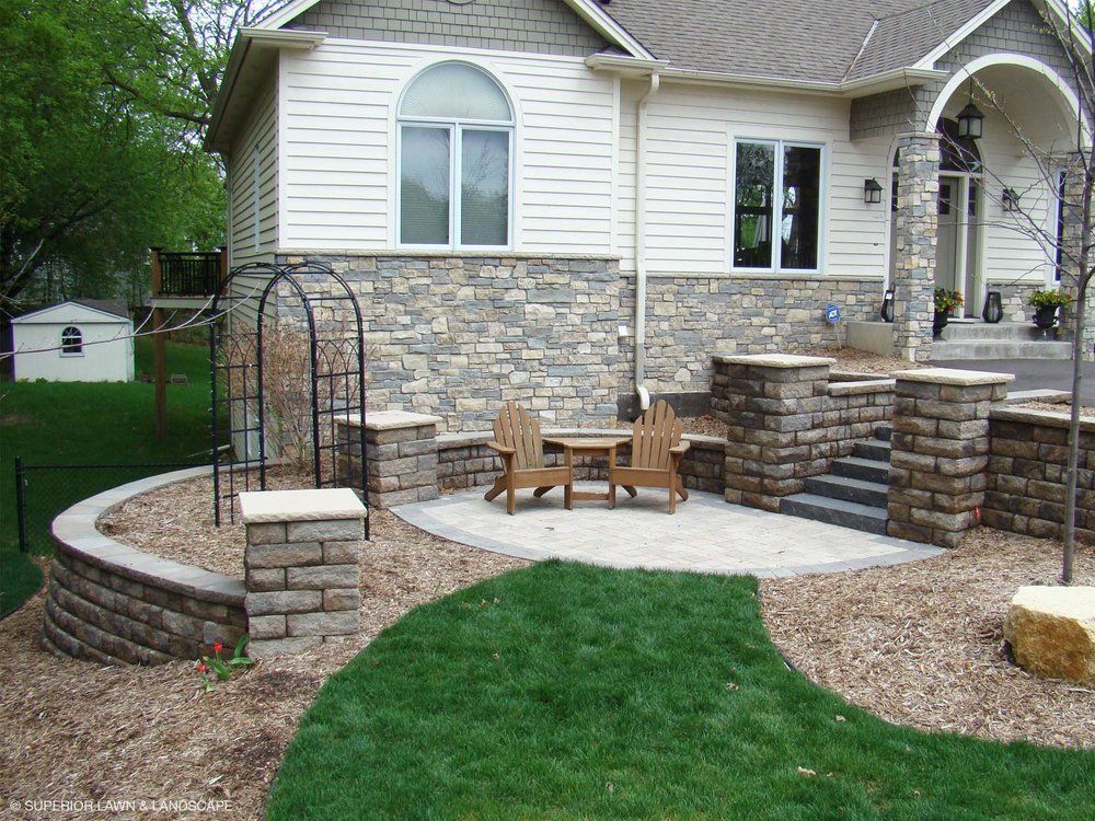 A house with a patio and chairs in front of it