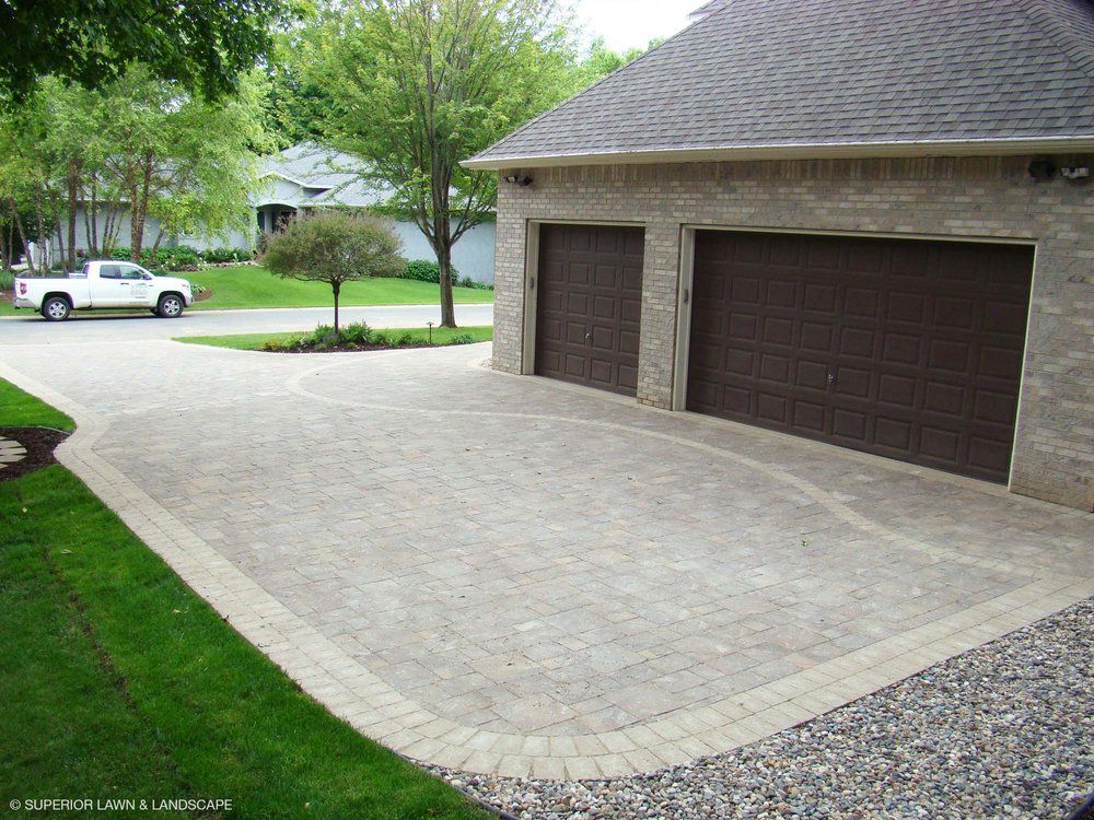 A white truck is parked in front of a garage