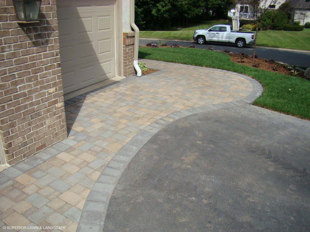 A white truck is parked in front of a brick building