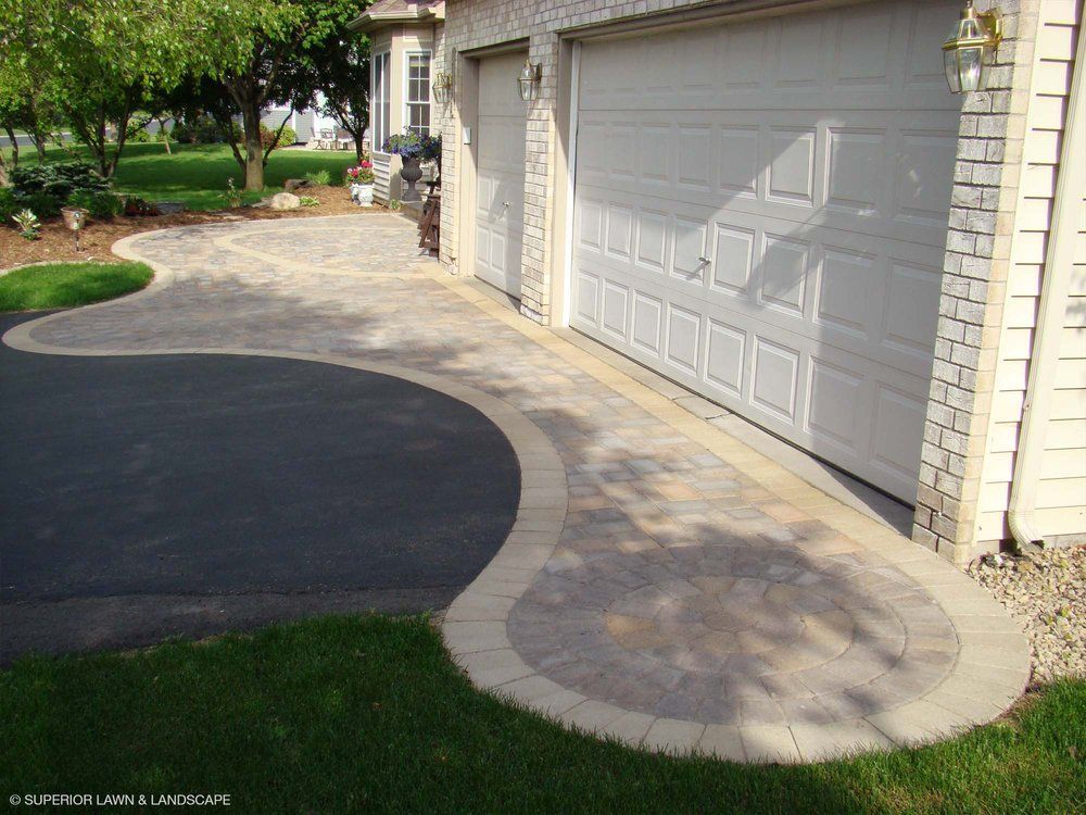 A driveway leading to a garage with a white garage door
