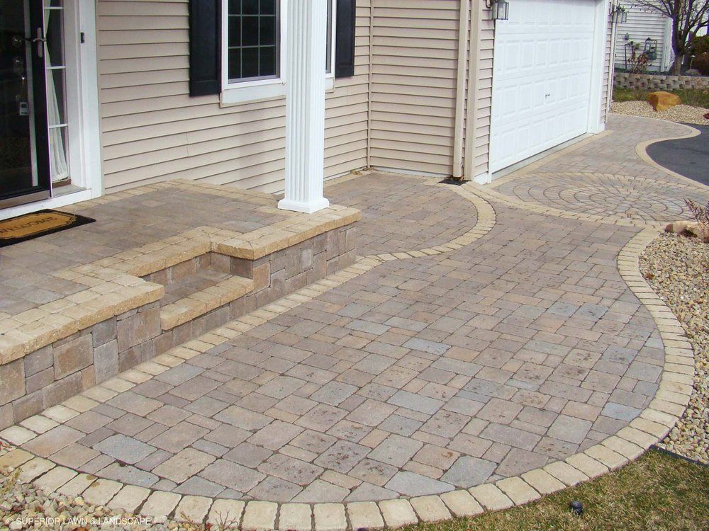 A brick walkway leading to the front door of a house
