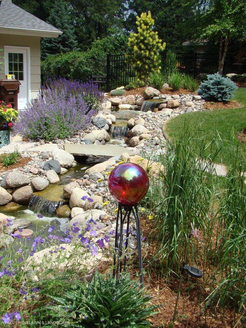 A garden with a red ball in the middle of it