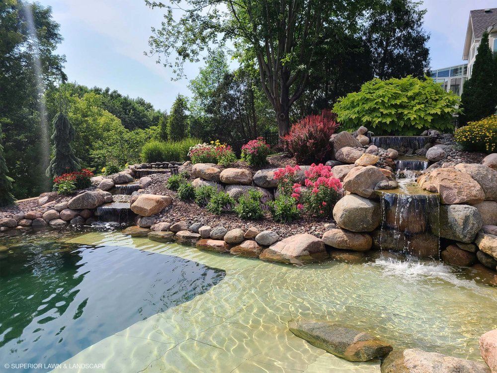 A pond with a waterfall in the middle of it