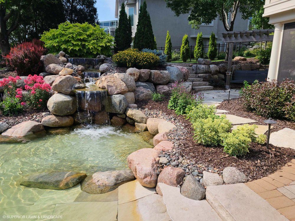 There is a waterfall in the middle of the garden.
