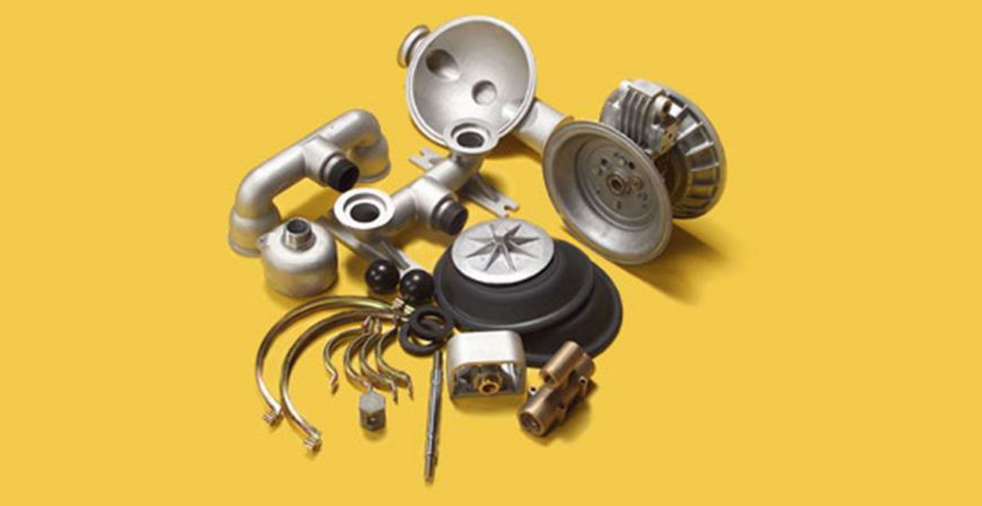 A bunch of metal parts on a yellow background